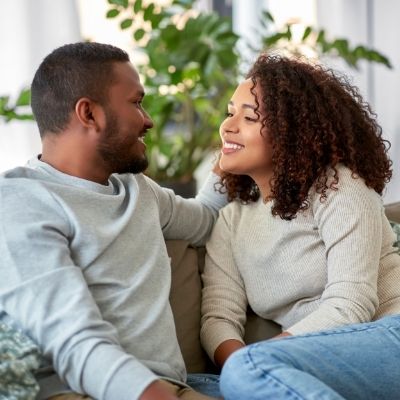 Couple sharing a happy moment on the couch.